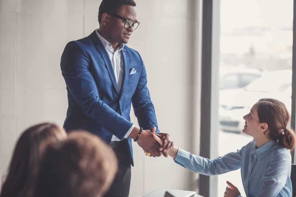 Business handshake and business people on deal concept