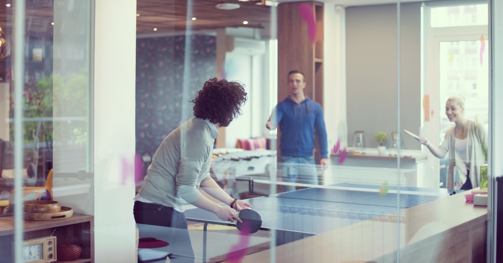 An office team playing ping pong during a break