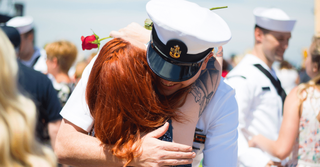 A Navy service members hugs his wife.
